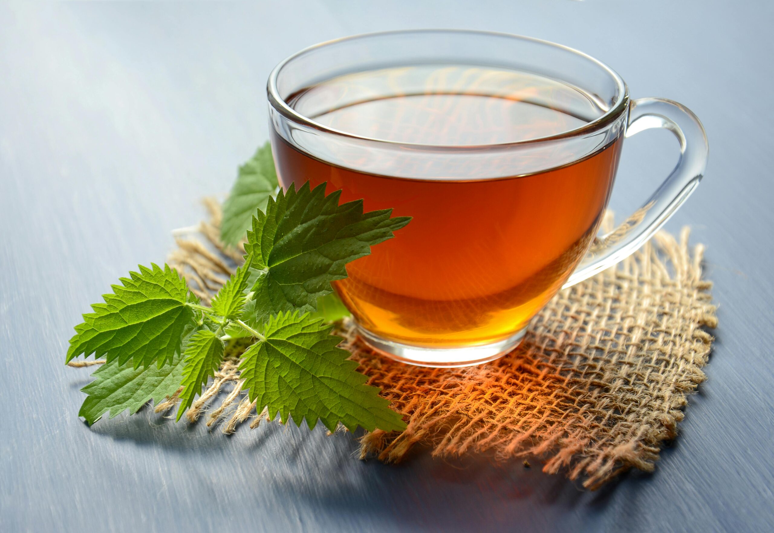 Ginger tea with mint and lemon on a wooden table