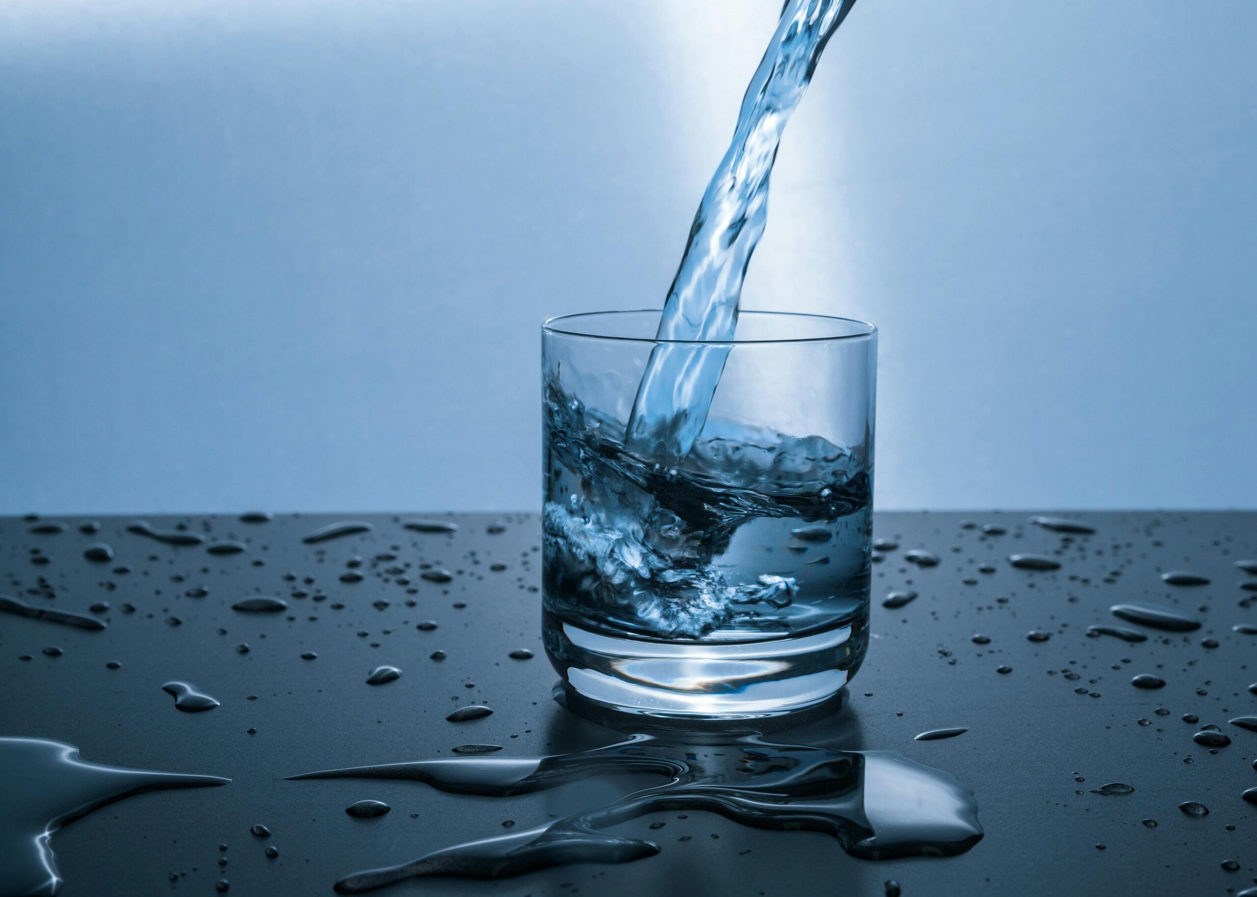 Glass of water with lemon wedge for hydration