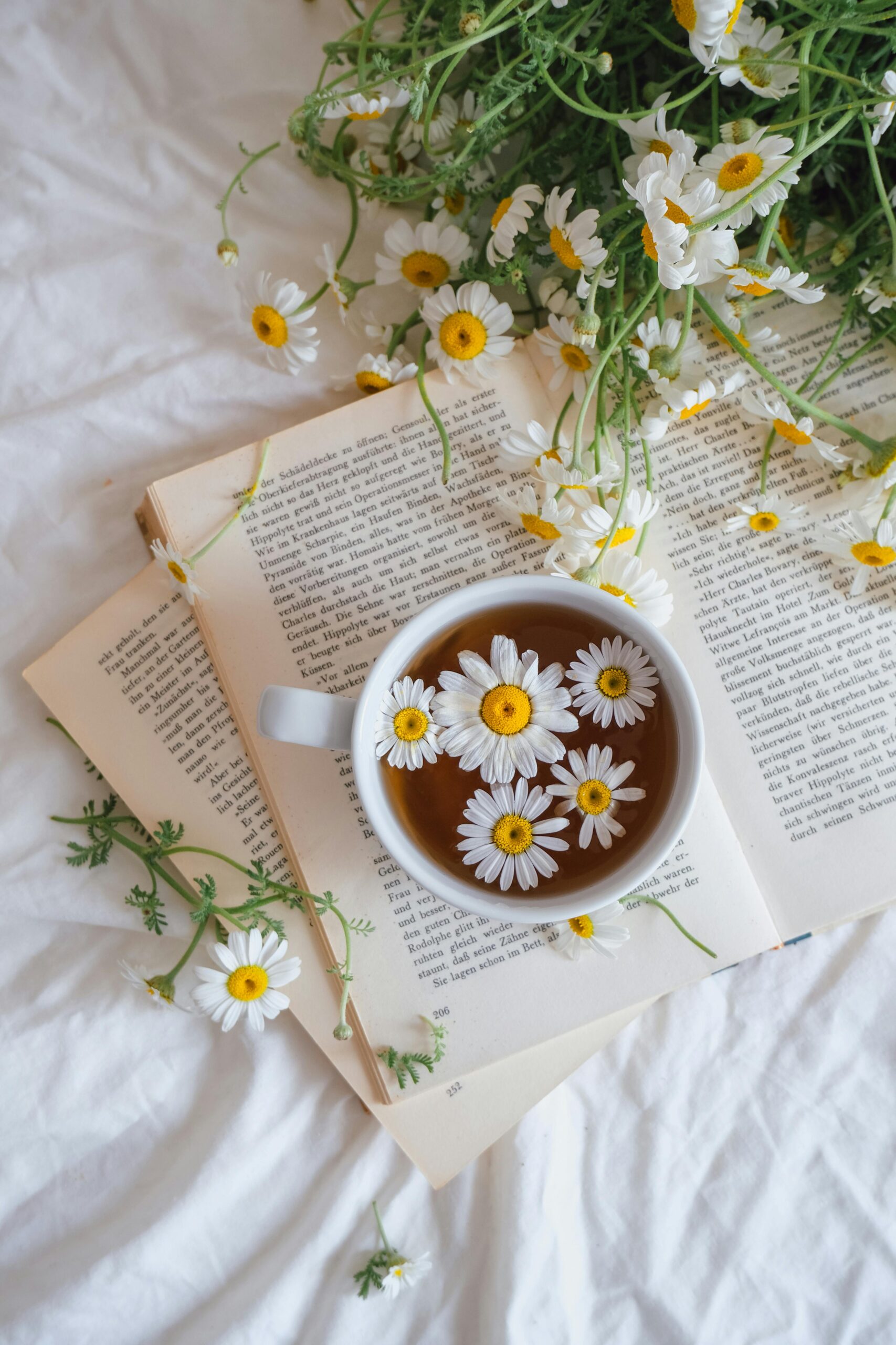 Menstrual cramp remedies with herbal tea, heating pad, and flowers on a cozy background.